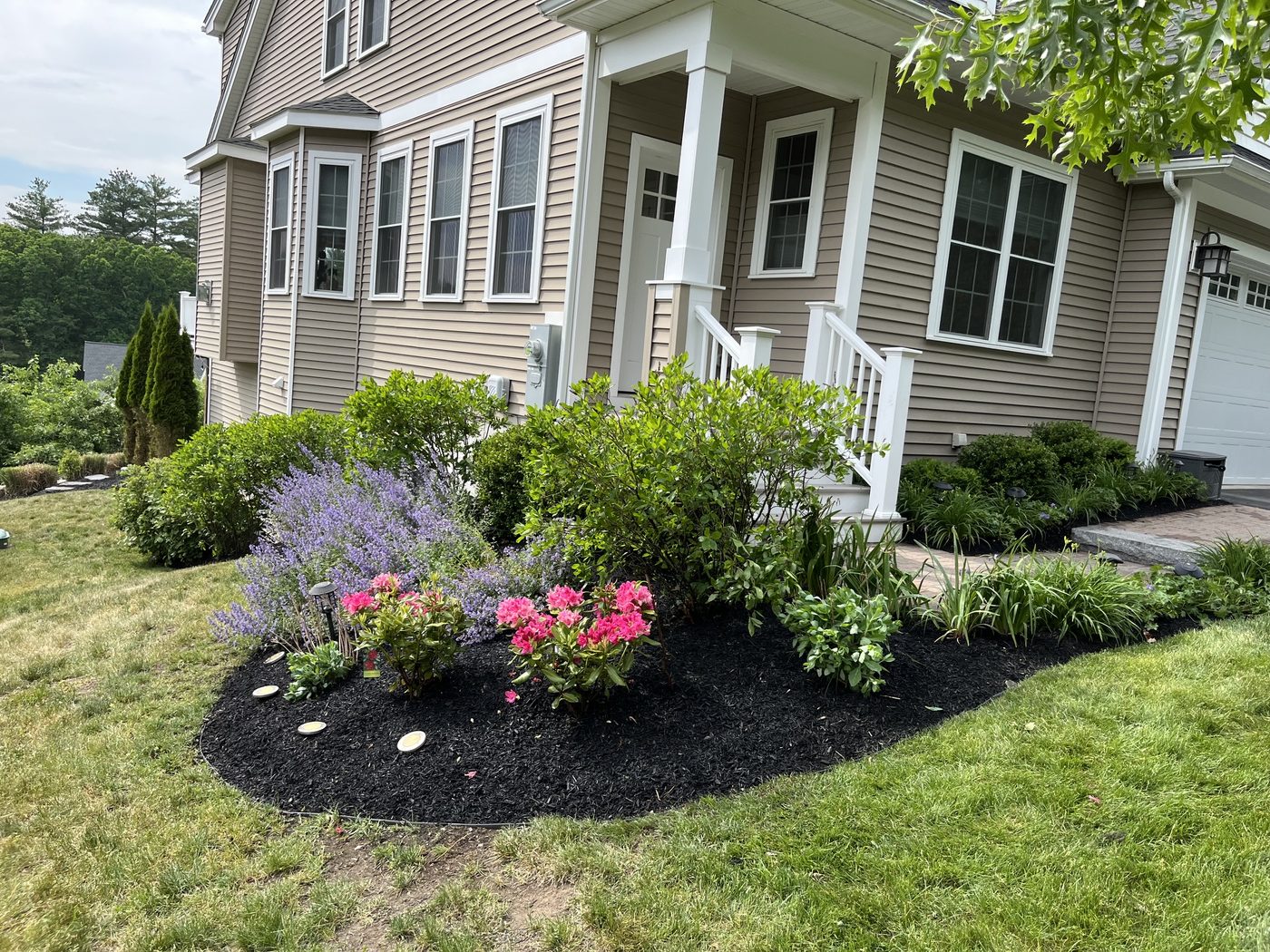 Paver walkway with a full flowering planting bed